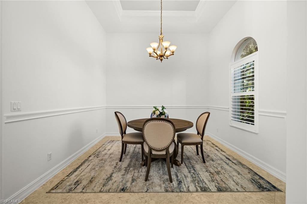 12553 Grandezza Circle Estero, FL 33928 - Photo 15 of 46 a view of a dining room with furniture and wooden floor