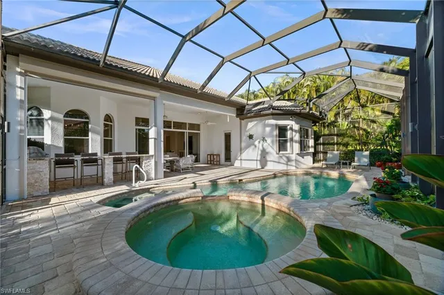 a swimming pool with outdoor seating and yard