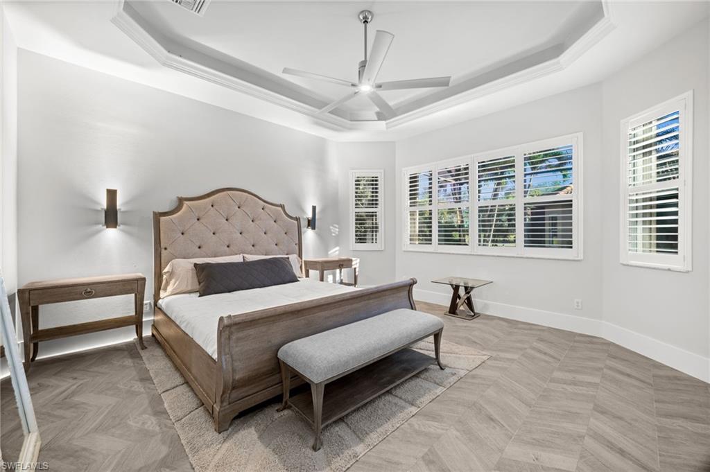 12553 Grandezza Circle Estero, FL 33928 - Photo 22 of 46 a bedroom with a bed and wooden floor