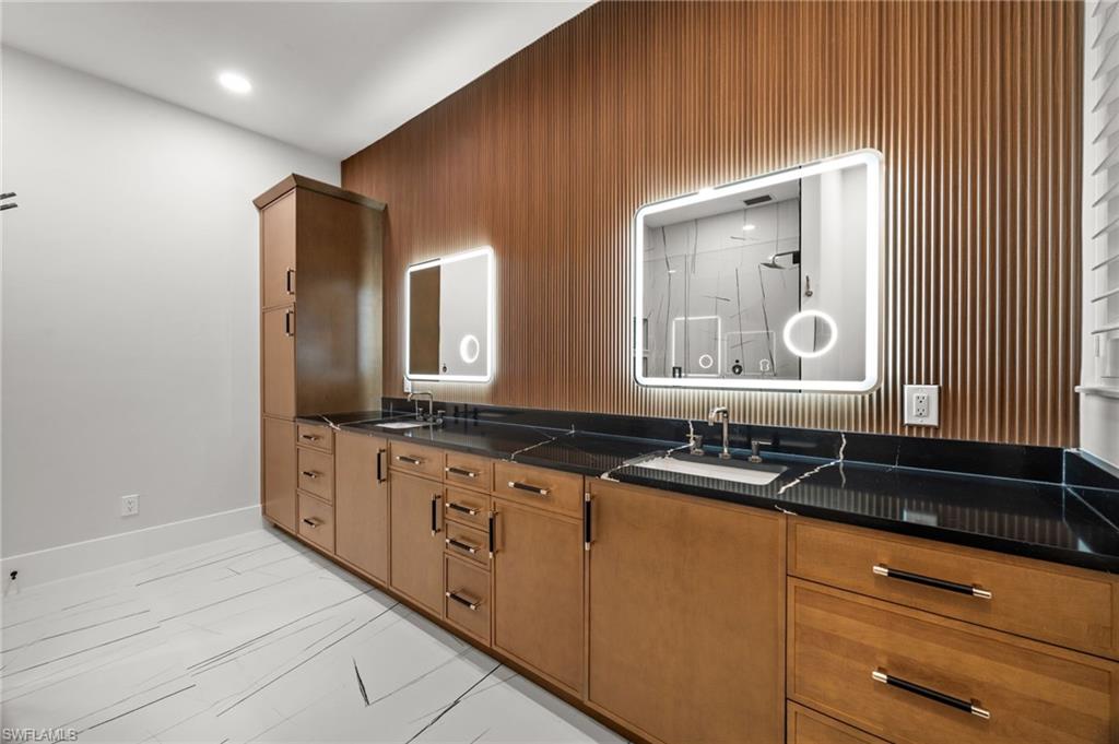 12553 Grandezza Circle Estero, FL 33928 - Photo 26 of 46 a bathroom with double sink and a mirror