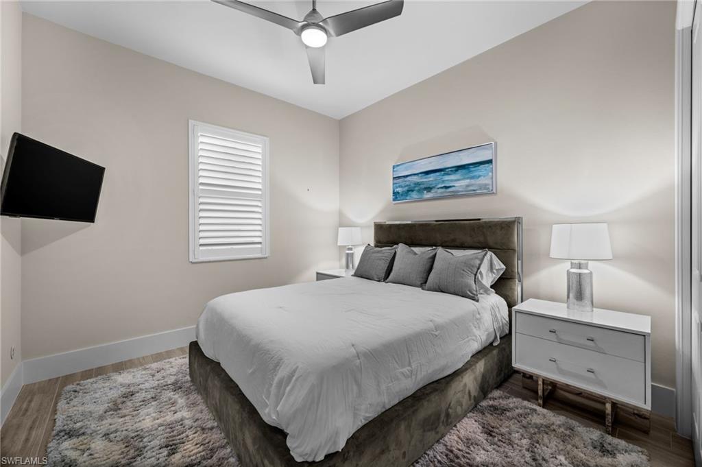 12553 Grandezza Circle Estero, FL 33928 - Photo 28 of 46 a bedroom with a bed and a flat screen tv