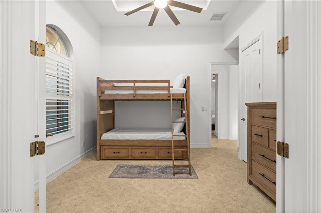 12553 Grandezza Circle Estero, FL 33928 - Photo 32 of 46 a room that has a bed and a chair in it