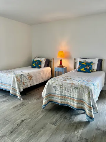 a bedroom with two beds and a couch