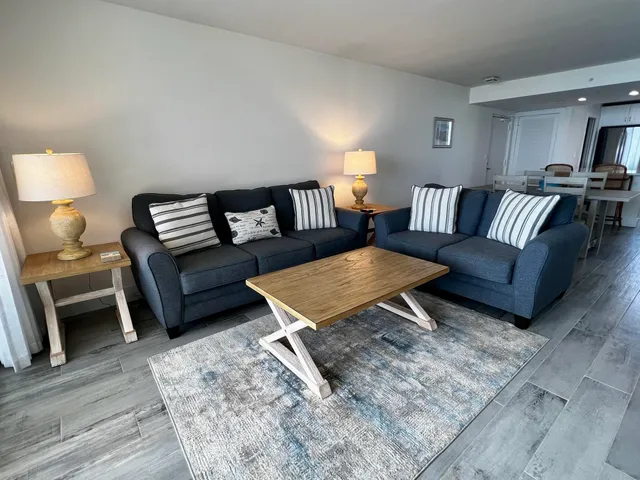 a living room with furniture rug and lamp