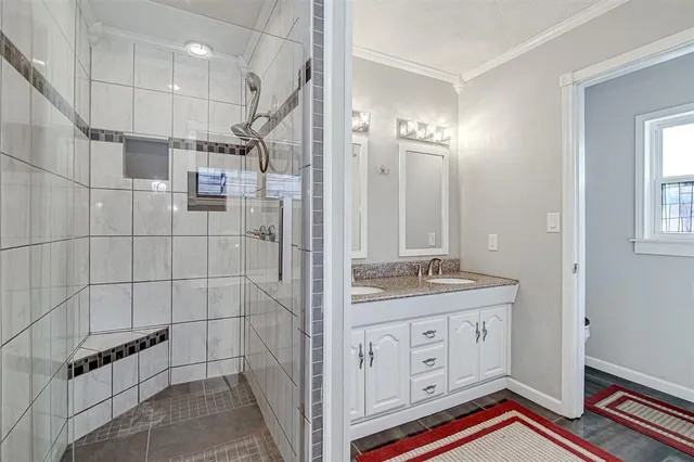 a bathroom with a sink vanity and a mirror