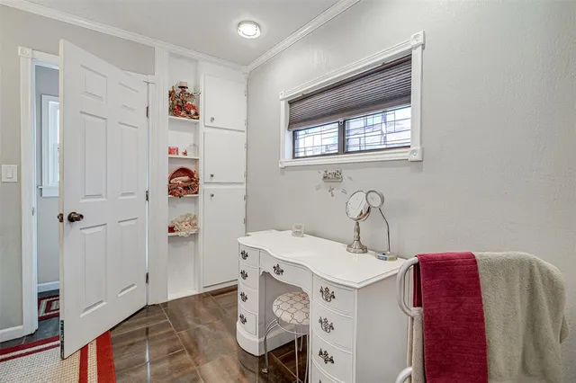 a bathroom with a granite countertop sink a toilet a mirror and shower