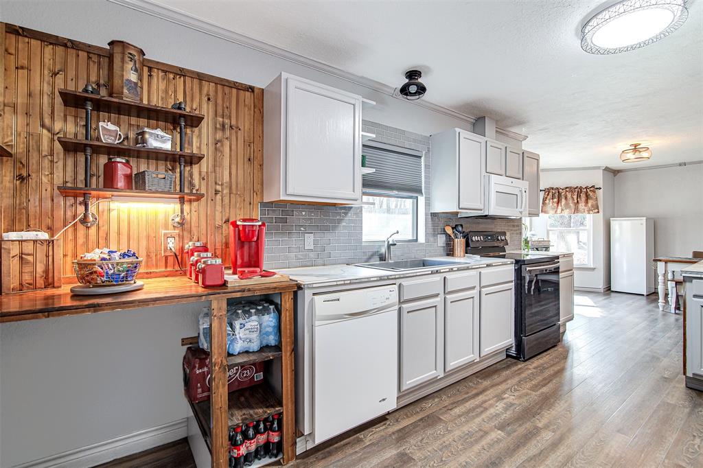 2521 Timber Road Burleson, TX 76028 - Photo 18 of 34 a kitchen with stainless steel appliances granite countertop a stove and cabinets