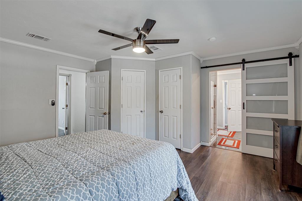 2521 Timber Road Burleson, TX 76028 - Photo 23 of 34 a bedroom with a bed and a chandelier