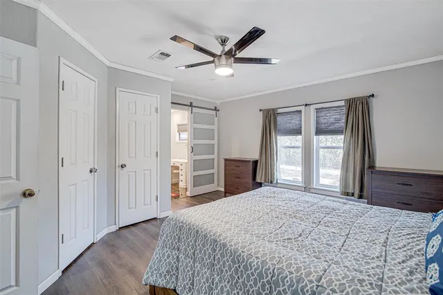 a bedroom with a bed and a dresser