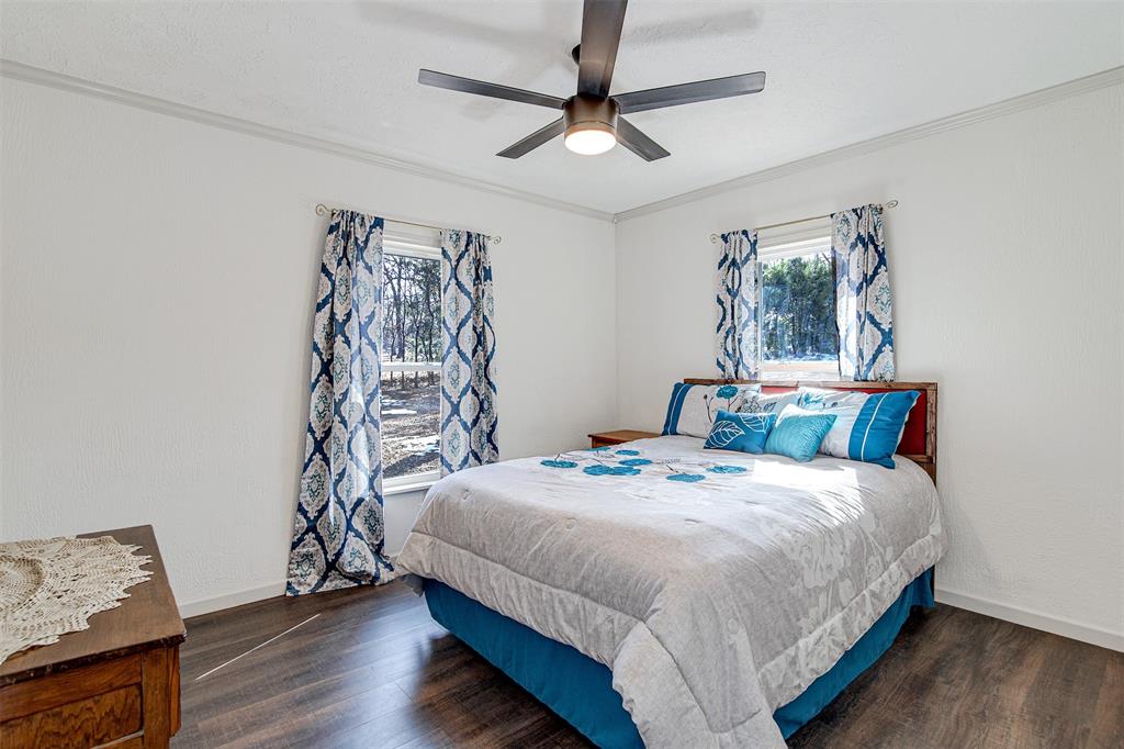 2521 Timber Road Burleson, TX 76028 - Photo 8 of 34 a bedroom with a bed and wooden floor