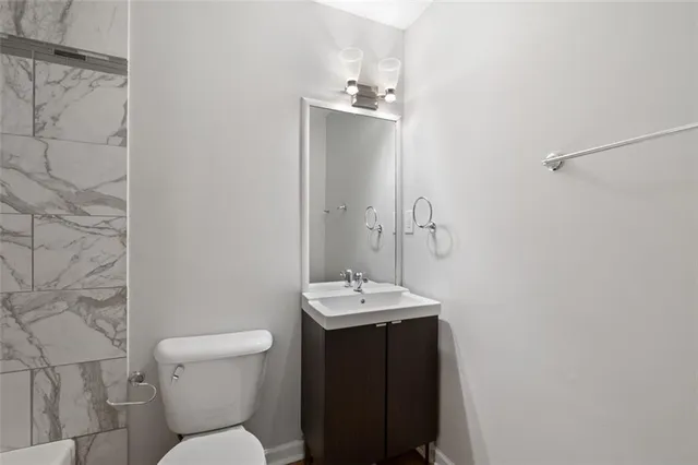 a bathroom with a sink toilet and shower