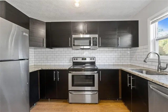 a kitchen with a sink stove and refrigerator