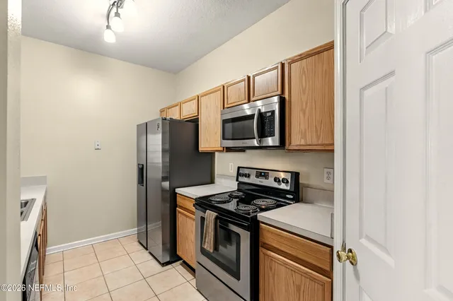 a kitchen with stainless steel appliances a refrigerator stove and microwave
