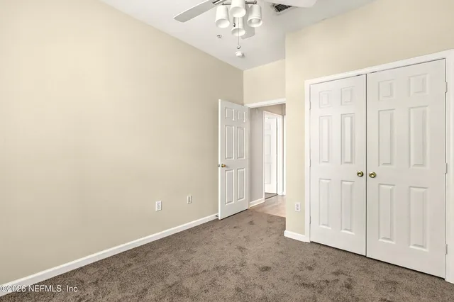 a view of a hallway with chandelier