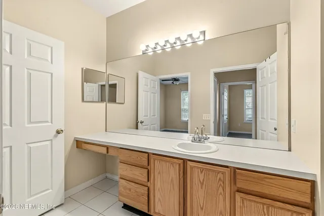 a bathroom with a double vanity sink and a mirror