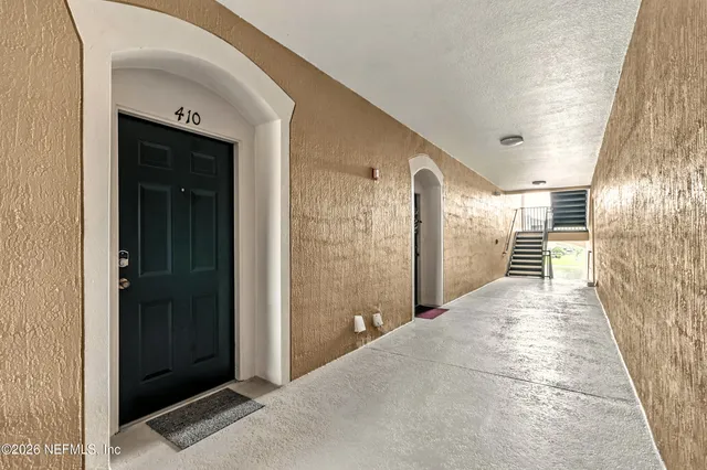 a view of a hallway with wooden shelves