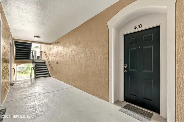a view of a hallway with wooden shelves