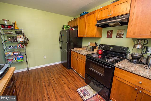 31403 Melson Road Delmar, MD 21875 - Photo 11 of 38 a kitchen with stainless steel appliances granite countertop a stove and a refrigerator