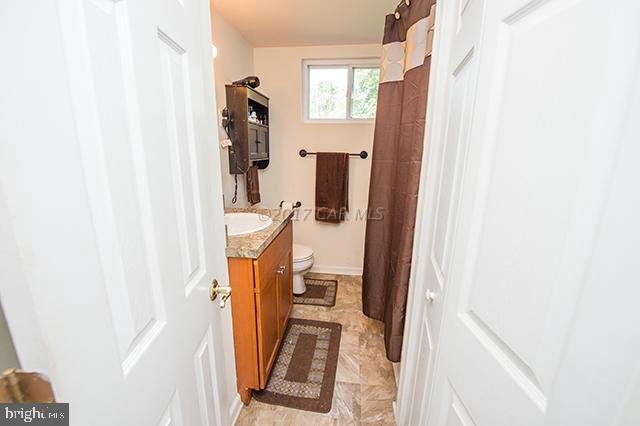 31403 Melson Road Delmar, MD 21875 - Photo 13 of 38 a view of a bedroom with wooden floor and windows