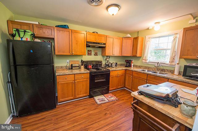 31403 Melson Road Delmar, MD 21875 - Photo 7 of 38 a kitchen with stainless steel appliances a refrigerator sink and cabinets