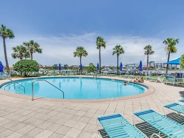 a swimming pool with outdoor seating and plants