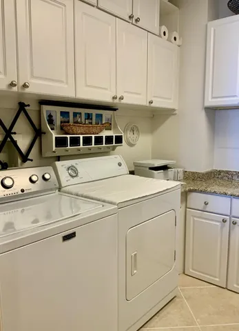 a bedroom with a bed a window and painting on the wall