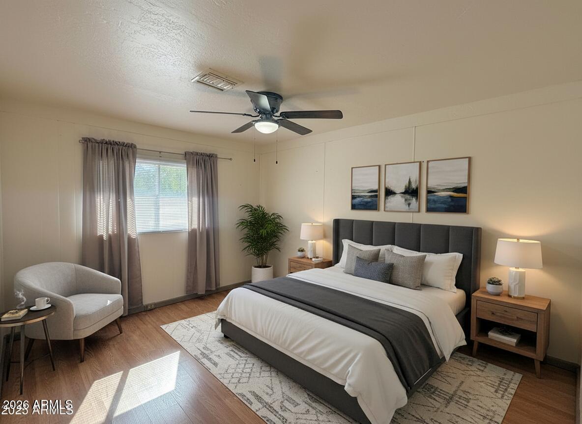 150 West North Street Ajo, AZ 85321 - Photo 17 of 37 a bedroom with a bed and a chandelier