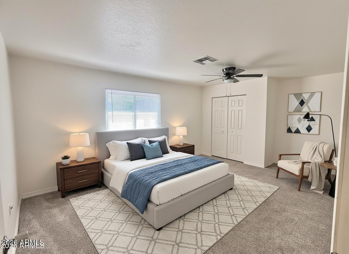 150 West North Street Ajo, AZ 85321 - Photo 20 of 37 a bedroom with a bed and a chandelier