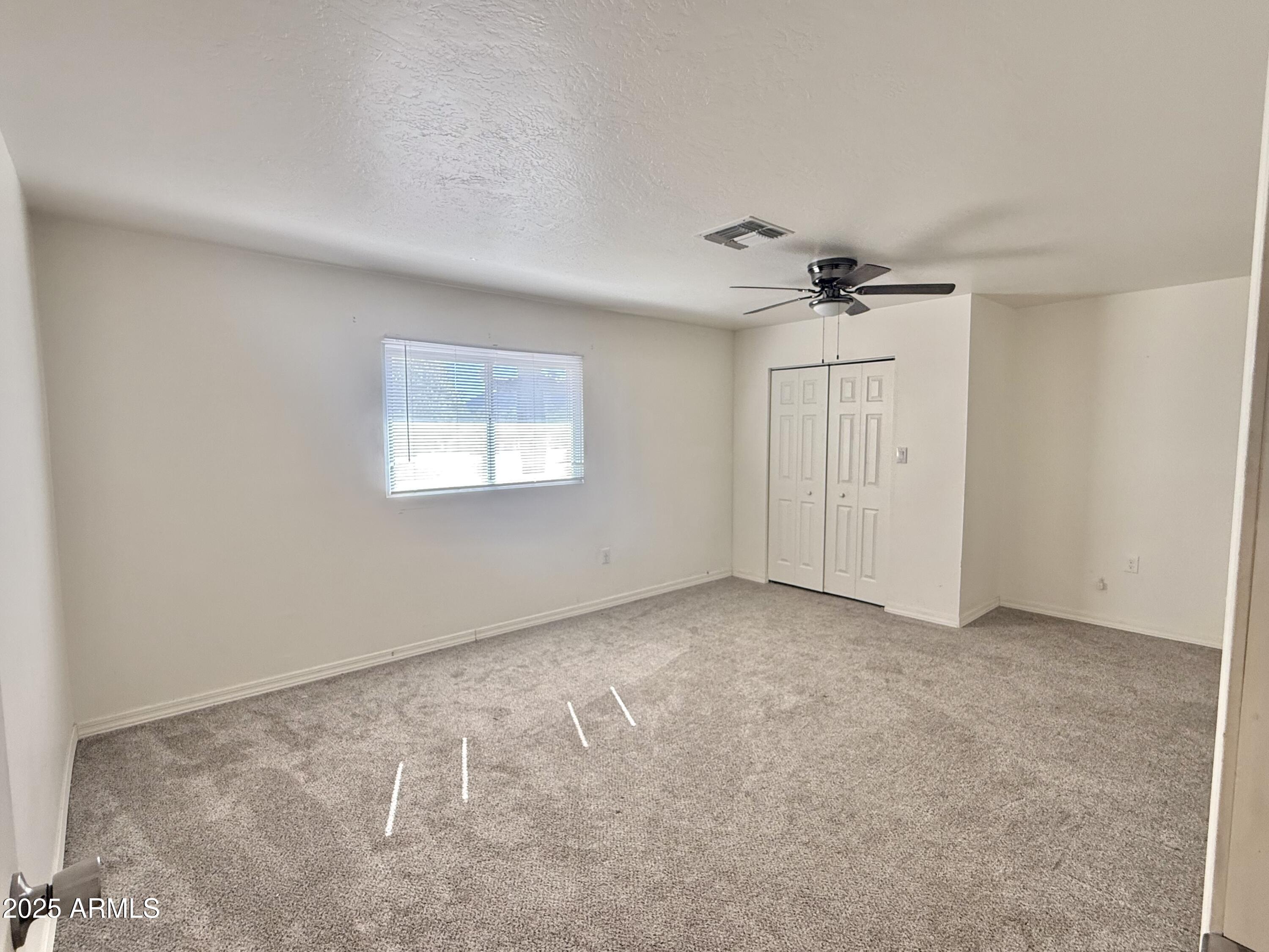 150 West North Street Ajo, AZ 85321 - Photo 21 of 37 an empty room with windows and fan