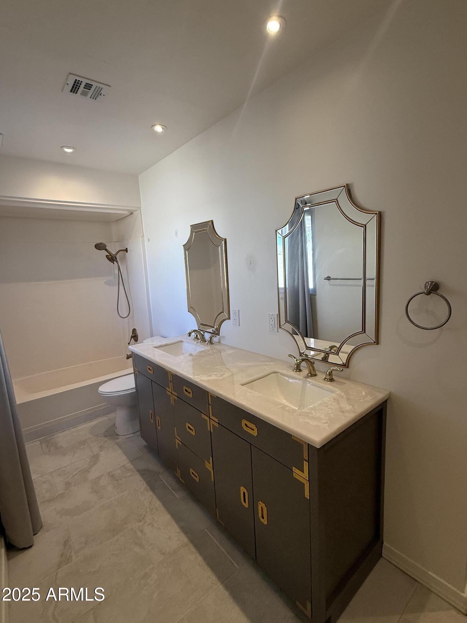 150 West North Street Ajo, AZ 85321 - Photo 23 of 37 a bathroom with a double vanity sink toilet and mirror