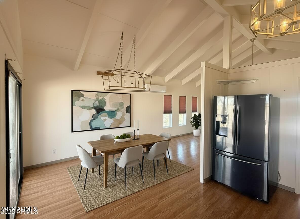 150 West North Street Ajo, AZ 85321 - Photo 7 of 37 a kitchen with stainless steel appliances granite countertop a refrigerator a microwave a stove and white countertops with wooden floor