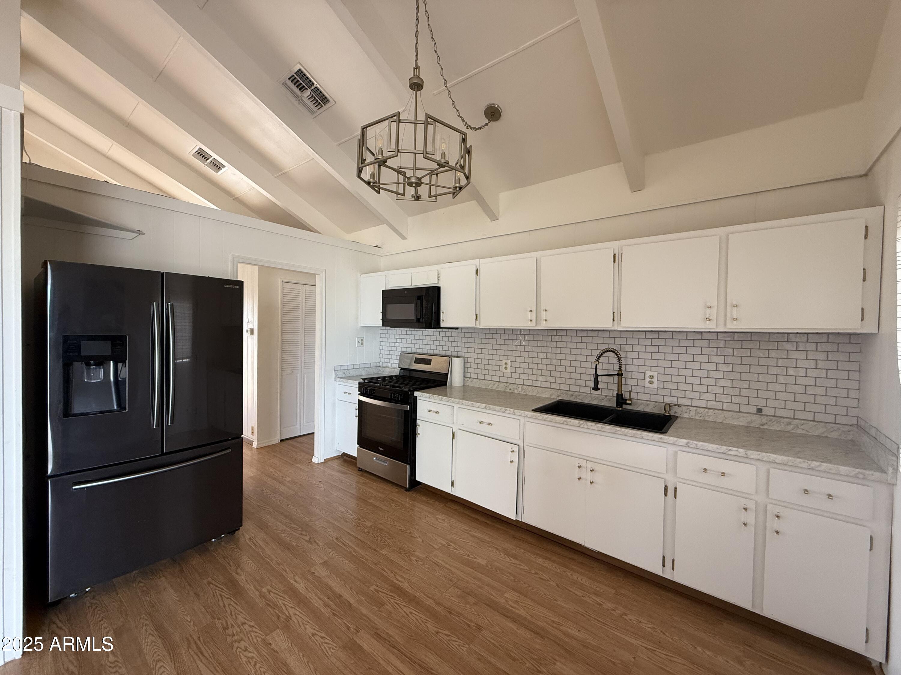 150 West North Street Ajo, AZ 85321 - Photo 10 of 37 a kitchen with stainless steel appliances a sink a stove a refrigerator and cabinets