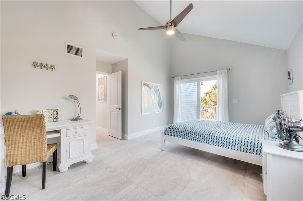 785 Rabbit Road Sanibel, FL 33957 - Photo 17 of 32 a spacious bedroom with a bed and a table
