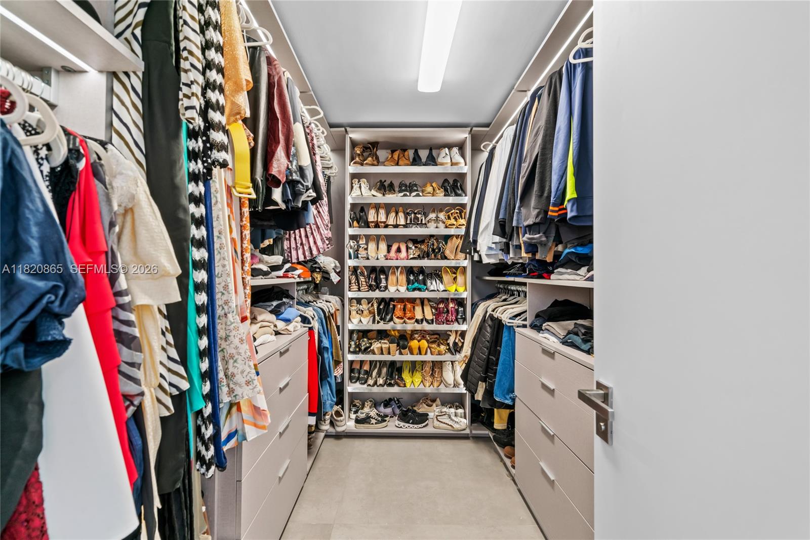9033 Emerson Avenue Surfside, FL 33154 - Photo 15 of 40 a view of walk in closet with clothes and shoes