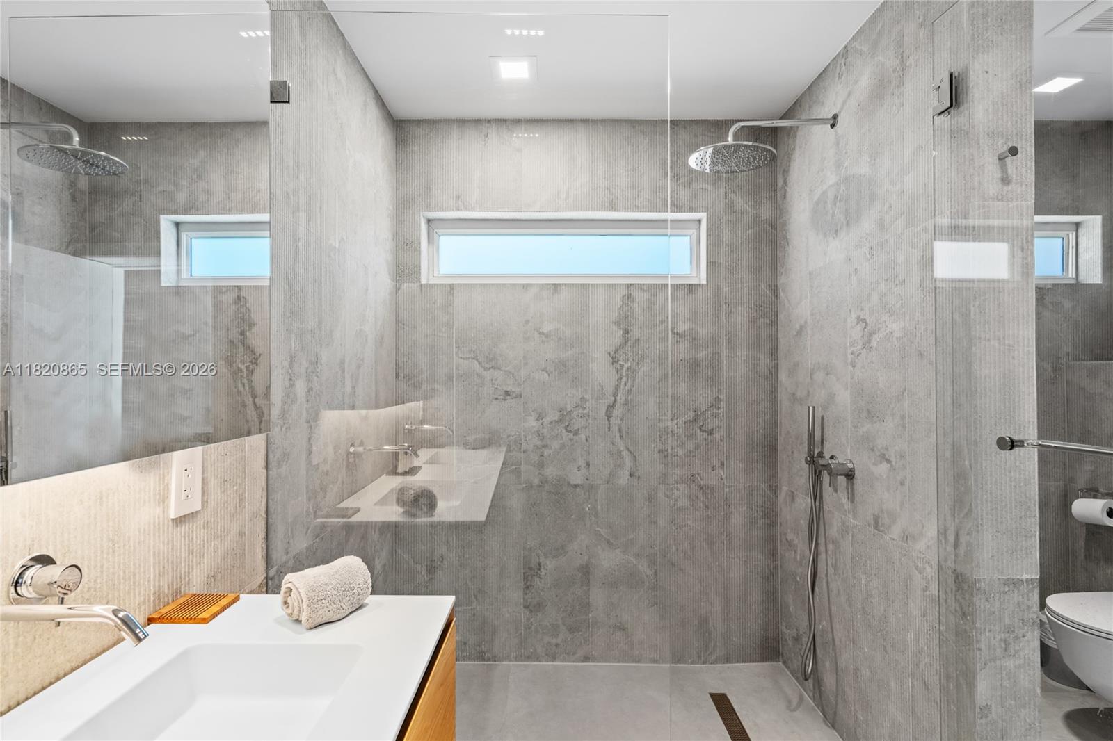 9033 Emerson Avenue Surfside, FL 33154 - Photo 17 of 40 a bathroom with a sink and a shower