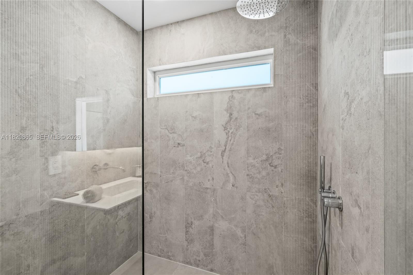 9033 Emerson Avenue Surfside, FL 33154 - Photo 18 of 40 a bathroom with a shower