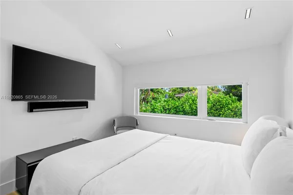 a bedroom with a bed and a window