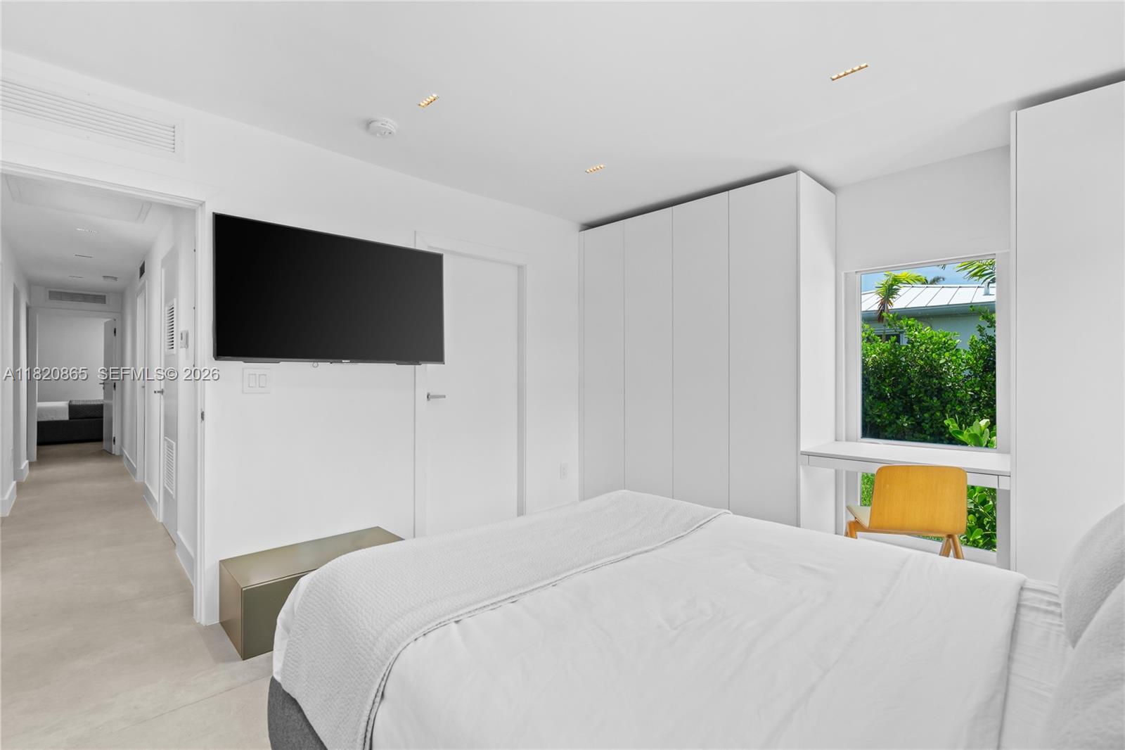 9033 Emerson Avenue Surfside, FL 33154 - Photo 24 of 40 a bedroom with a bed and a flat screen tv