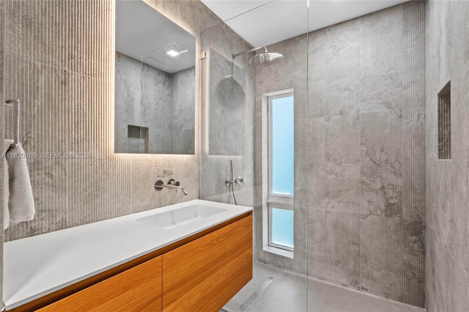 9033 Emerson Avenue Surfside, FL 33154 - Photo 25 of 40 a bathroom with a bathtub and a sink