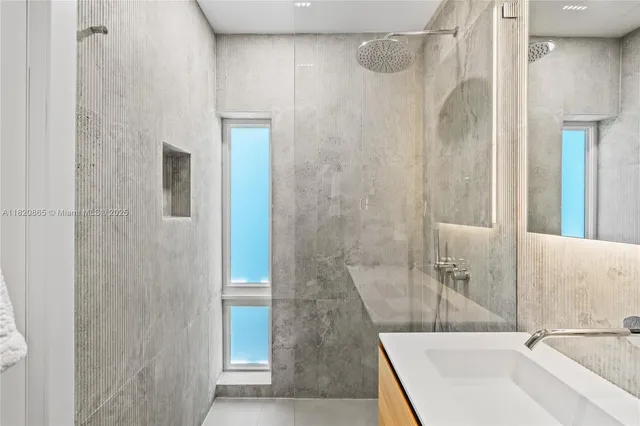 a living room with patio furniture and garden view