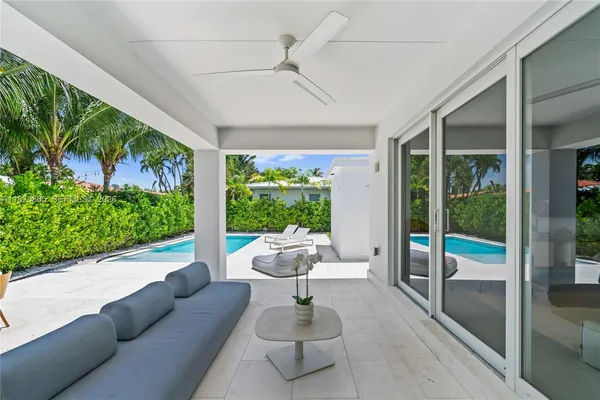 a view of a patio with a table and chairs under an umbrella