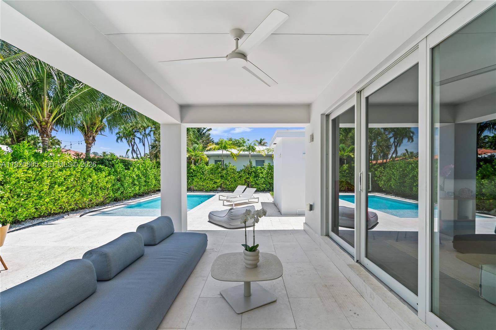 9033 Emerson Avenue Surfside, FL 33154 - Photo 31 of 40 a living room with patio furniture and garden view