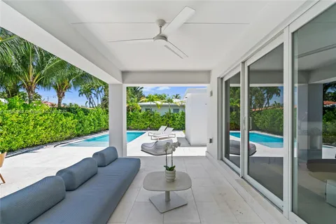 a view of a patio with a table and chairs under an umbrella