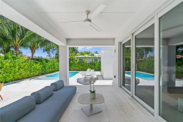 a view of a patio with a table and chairs under an umbrella