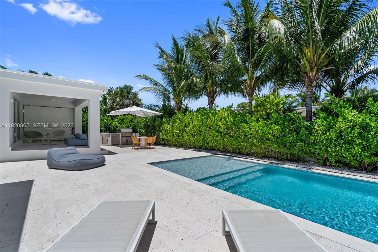 9033 Emerson Avenue Surfside, FL 33154 - Photo 33 of 40 a view of a patio with a table and chairs under an umbrella