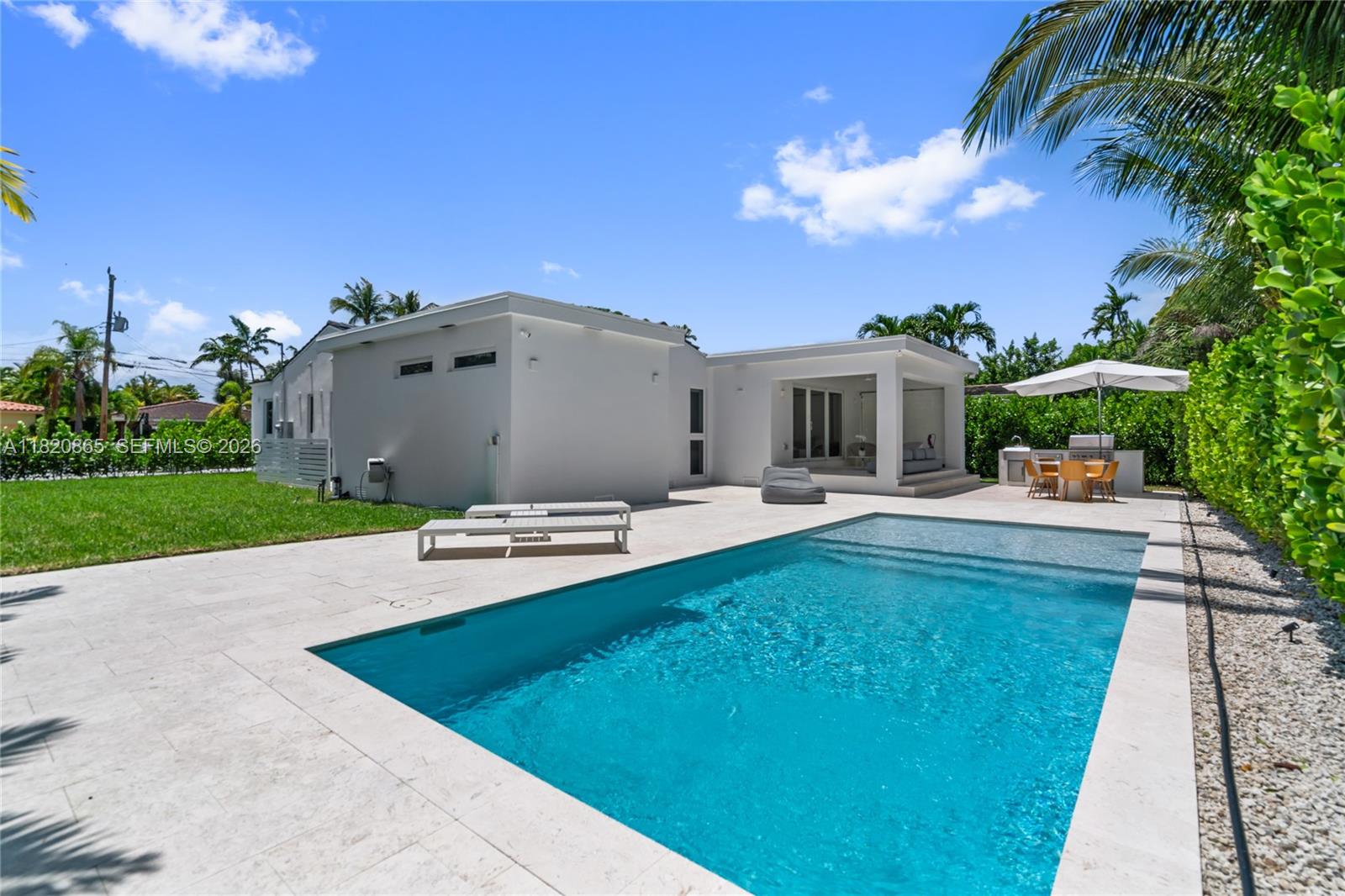 9033 Emerson Avenue Surfside, FL 33154 - Photo 36 of 40 a view of a house with pool and chairs