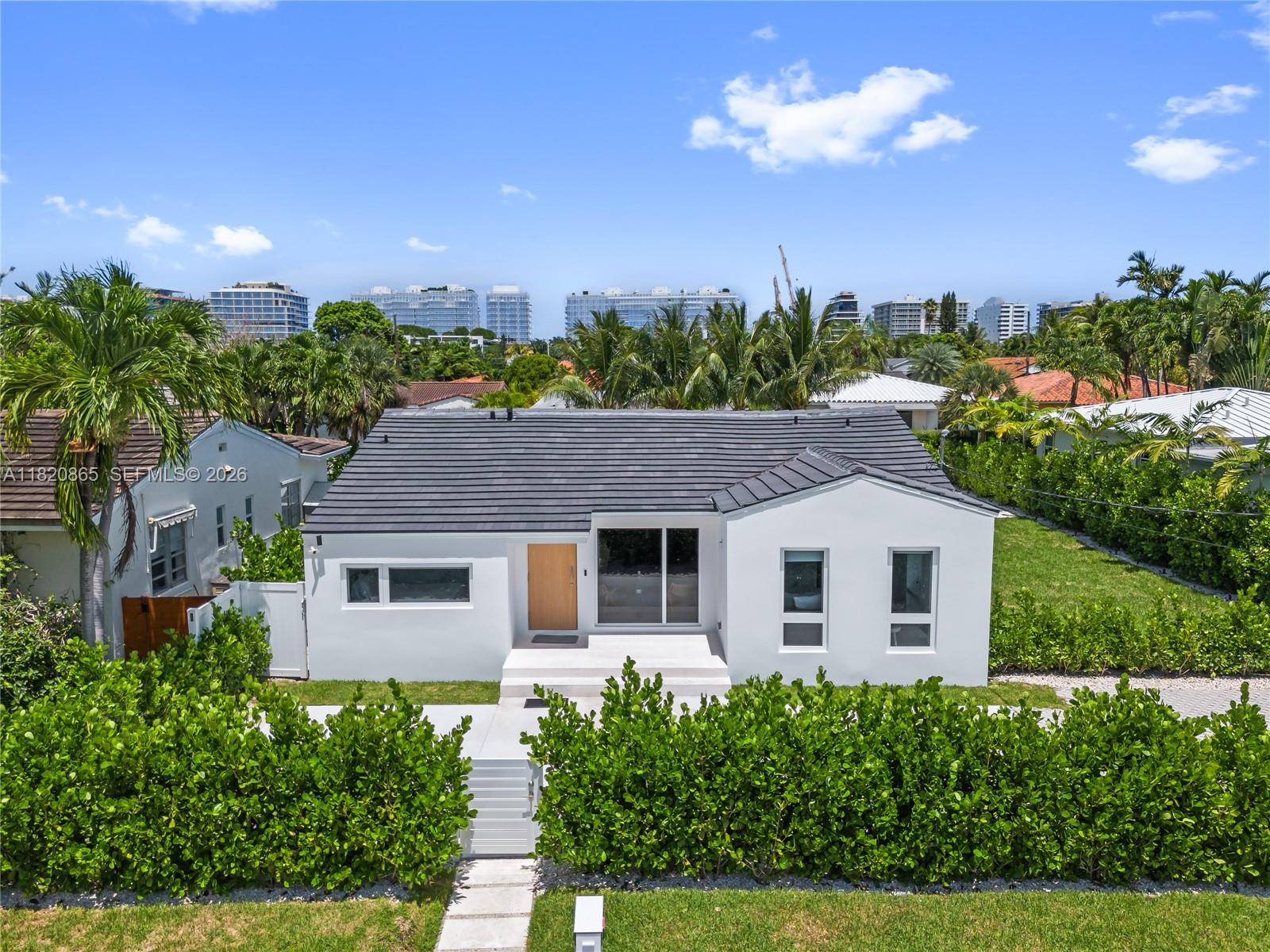 9033 Emerson Avenue Surfside, FL 33154 - Photo 37 of 40 a view of a house with a yard and potted plants