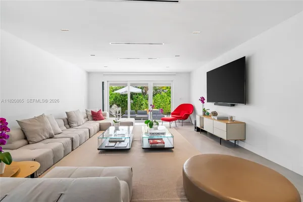 a living room with furniture and a flat screen tv