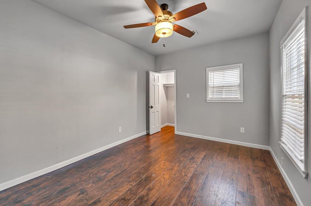 2001 Colcord Avenue Waco, TX 76707 - Photo 19 of 26 an empty room with wooden floor fan and windows