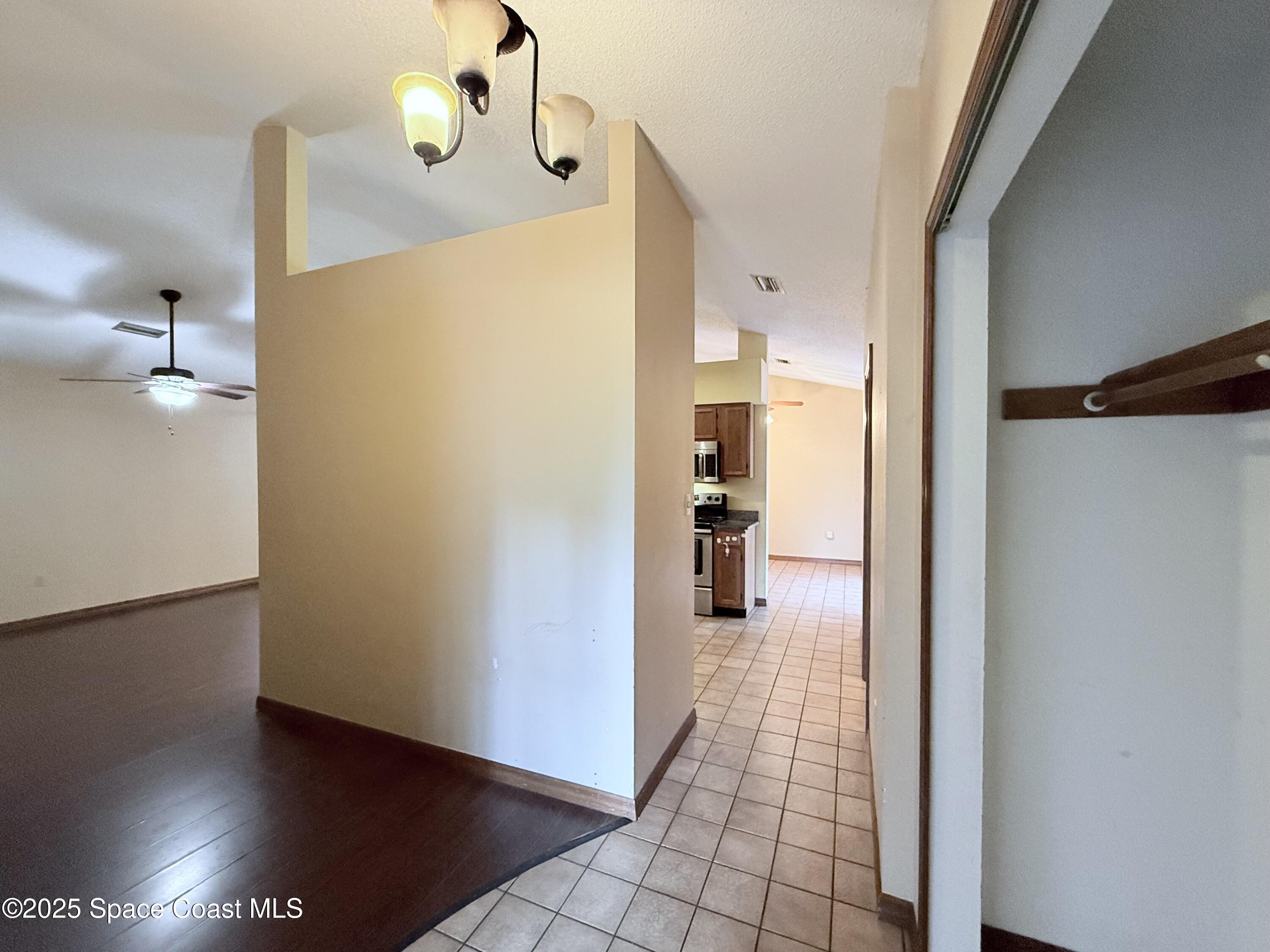 6180 Balboa Street Cocoa, FL 32927 - Photo 13 of 44 a view of a hallway with wooden floor